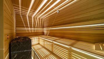 A sauna with wooden slats and a marble bench.