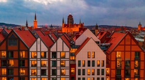 A row of traditional European buildings with visible windows and a prominent church in the background. - Radisson Hotel & Apartments Gdansk (Gdansk)