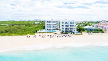 On the beach, white sand, sun-loungers, beach umbrellas