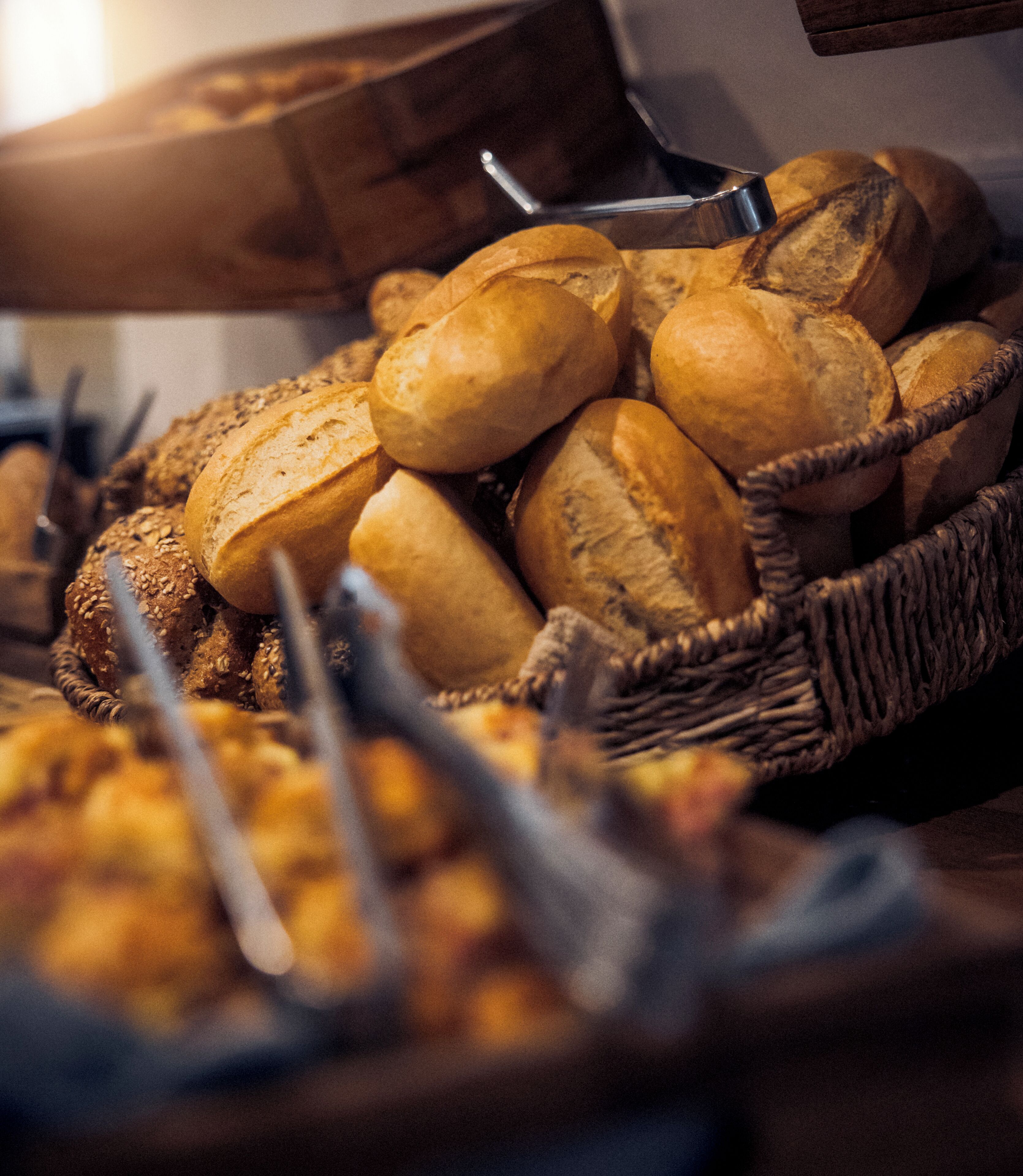 A basket of various breads and rolls.