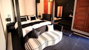 A modern bedroom with a large bed, a curved seating area, a mirror, and a wooden door. - Villa Rayane Marrakech (6rooms-14persons) (Marrakech)