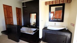 A modern bathroom with a large bathtub, a separate sink area, and wooden cabinets. - Villa Rayane Marrakech (6rooms-14persons) (Marrakech)
