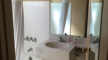 A bathroom with a bathtub, a sink, and a toilet.