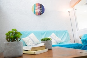 Relax in a comfortable space with a sofa, table, and decorative plate.