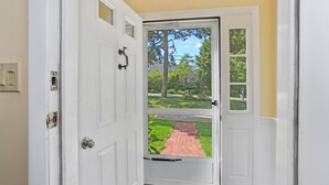 A white door with a glass panel, a doorknob, and a small window above the door. - Chatham-Walk to Ridgevale Beach, Winter Rental Option (Chatham)