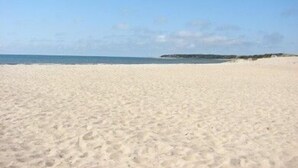 A wide sandy beach with a clear sky and calm sea. - Chatham-Walk to Ridgevale Beach, Winter Rental Option (Chatham)