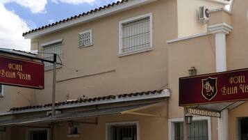 A hotel named 'Bella Vista' with a signboard displaying the hotel's name and logo.