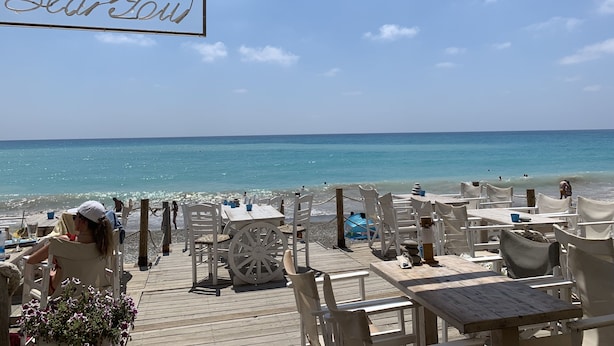 A beachside restaurant with outdoor seating, a sign reading "Dear Love," and a view of the ocean. - Luxury Private 3 bedroom (sleeps 6)Villa, Breathtaking Views & 200mbps Wi-Fi (Paphos)