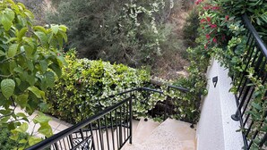 A staircase with a metal railing, surrounded by greenery and flowering plants. - Luxury Private 3 bedroom (sleeps 6)Villa, Breathtaking Views & 200mbps Wi-Fi (Paphos)