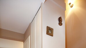 A staircase leading to a second floor with a wooden finish, a white door with a small decorative plate, and a dining area with two chairs and a table in the background. - house / villa - Hendaya with swimming pool (Hendaye)