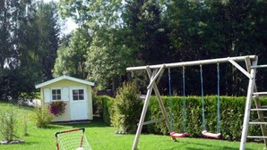 A grassy yard with a small shed, a swing set, and a soccer goal. - Family-friendly 4 * Holiday, Pets Allowed, N. Ground corn, Hiking (Kirchberg i. Wald)