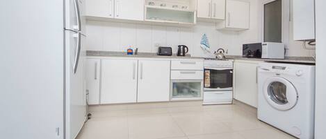 Fridge, microwave, coffee/tea maker, cookware/dishes/utensils