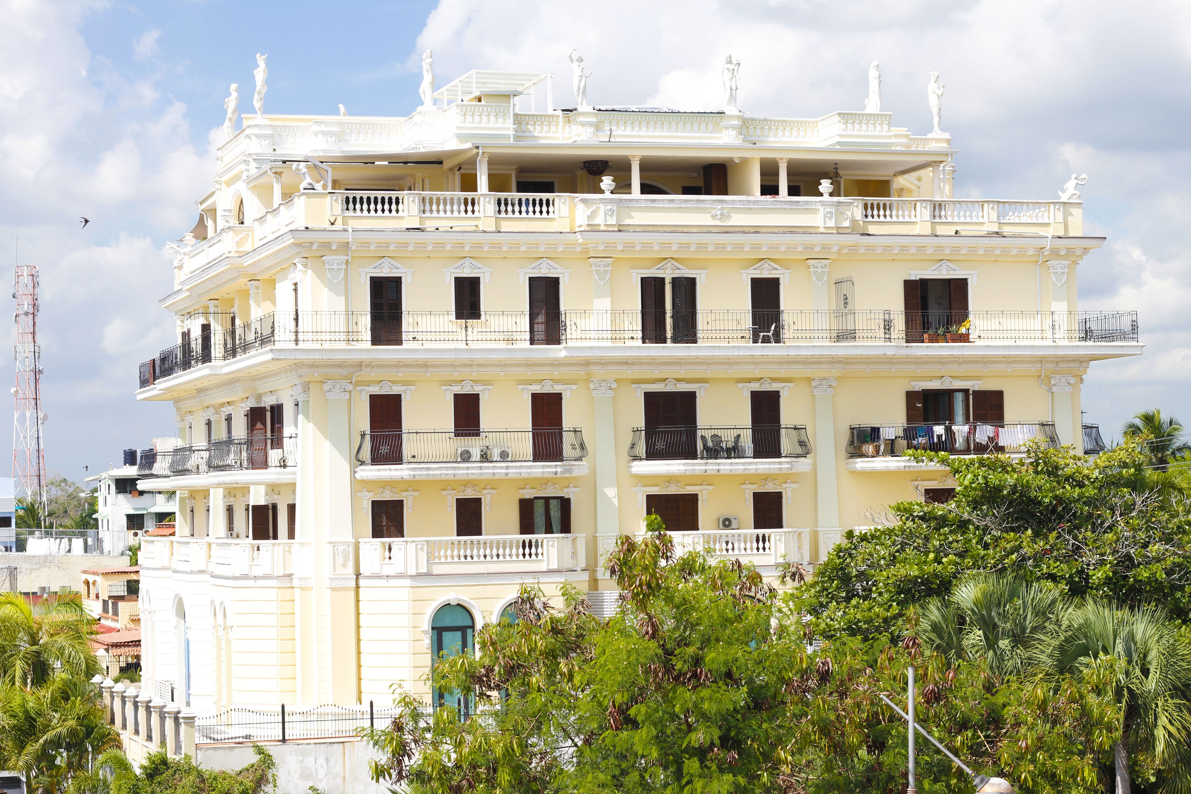 A multi-story building with balconies, large windows, and a classical architectural style.