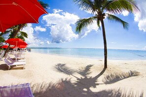 On the beach, sun-loungers