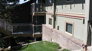 A multi-story building with a brick exterior, a balcony on the second floor, and a small window on the third floor. - Mountain Condo For All Season Fun And Relaxation/ Family Friendly 2Bath2Bedrooms (Steamboat Springs)
