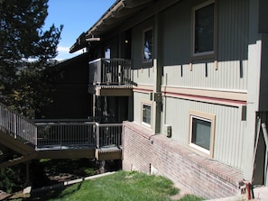 Stunning residential building with a brick facade and a flat roof, featuring a balcony and external stairs.