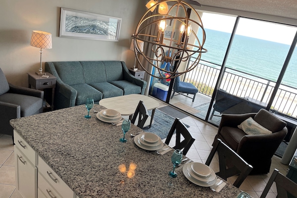 Modern kitchen with large peninsula. Has a great view and plenty of seating.