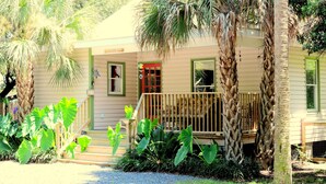 A house with a porch, a wooden railing, and a number '311' on the wall. - Great Family Beach House and 5% off weekly stays, last minute or mobile booking! (Folly Beach)