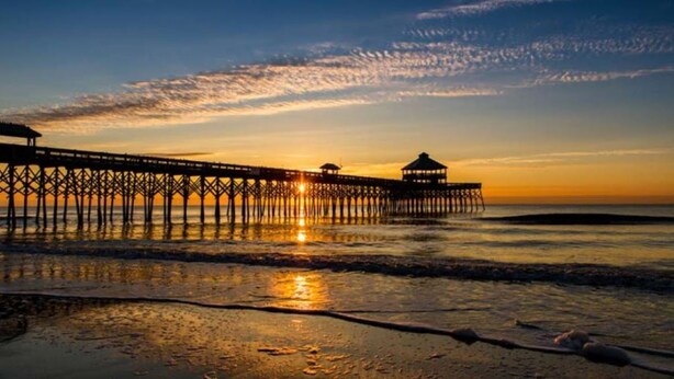 A pier extending into the water with a gazebo at the end, reflecting the sunset. - Great Family Beach House and 5% off weekly stays, last minute or mobile booking! (Folly Beach)