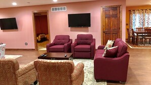 A living room with two sofas, a coffee table, and a television.