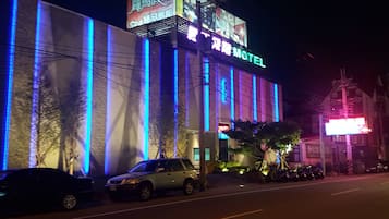 Conveniently located motel with a flat facade and large windows.
