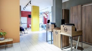 A modern hotel reception area with a check-in counter, seating area, and a view of the lobby. - B&B Hotel Roma Fiumicino Aeroporto Fiera 1 (Fiumicino)