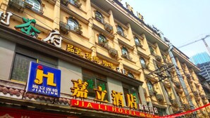 A hotel with a prominent sign, multiple floors, and balconies.