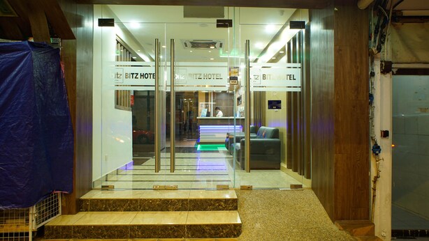 The entrance to a hotel with glass doors, a reception desk, and a sign indicating the name 'BITZ HOTEL'. - Bitz Hotel (Kuala Lumpur)
