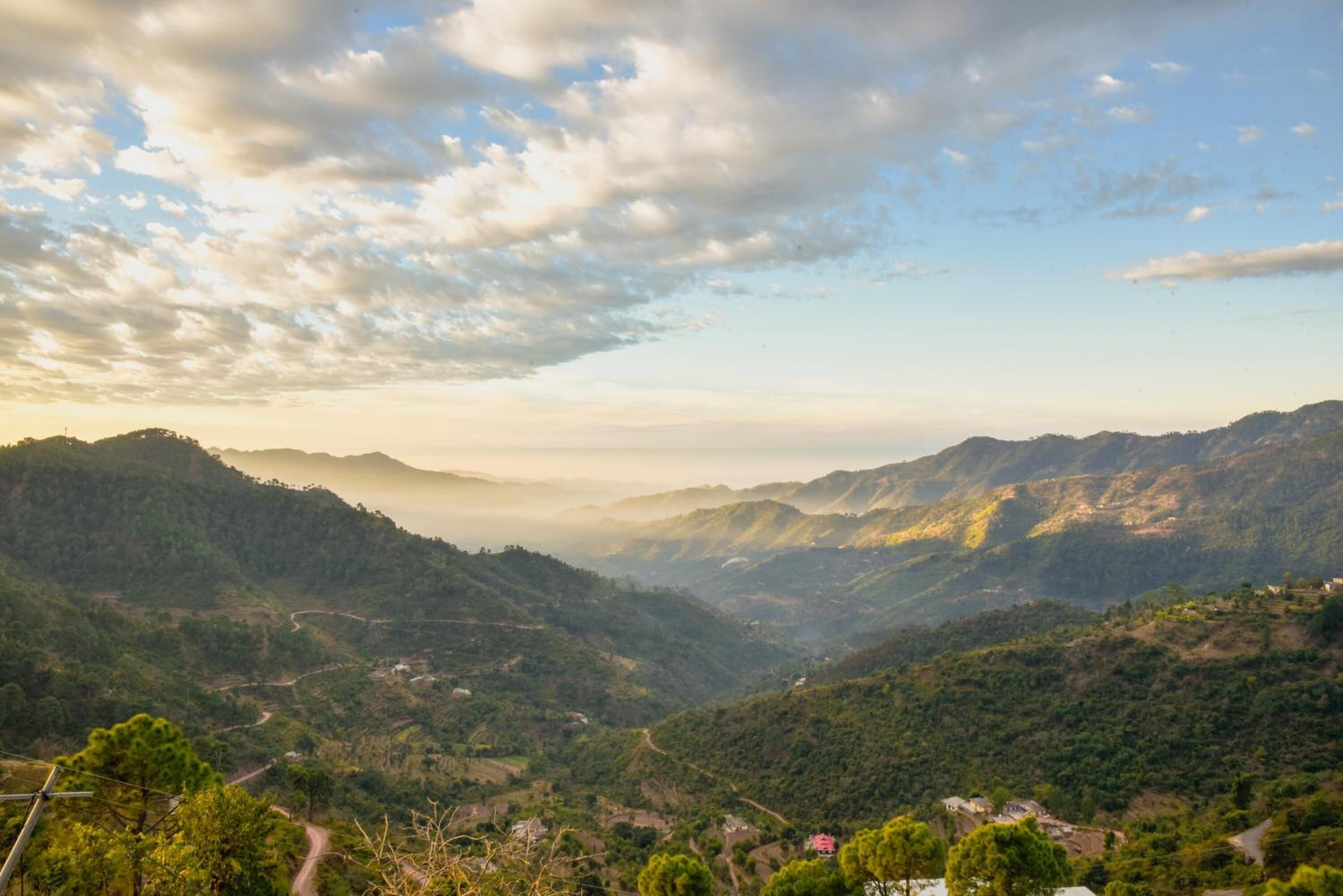 A mountainous landscape with winding roads and scattered buildings.