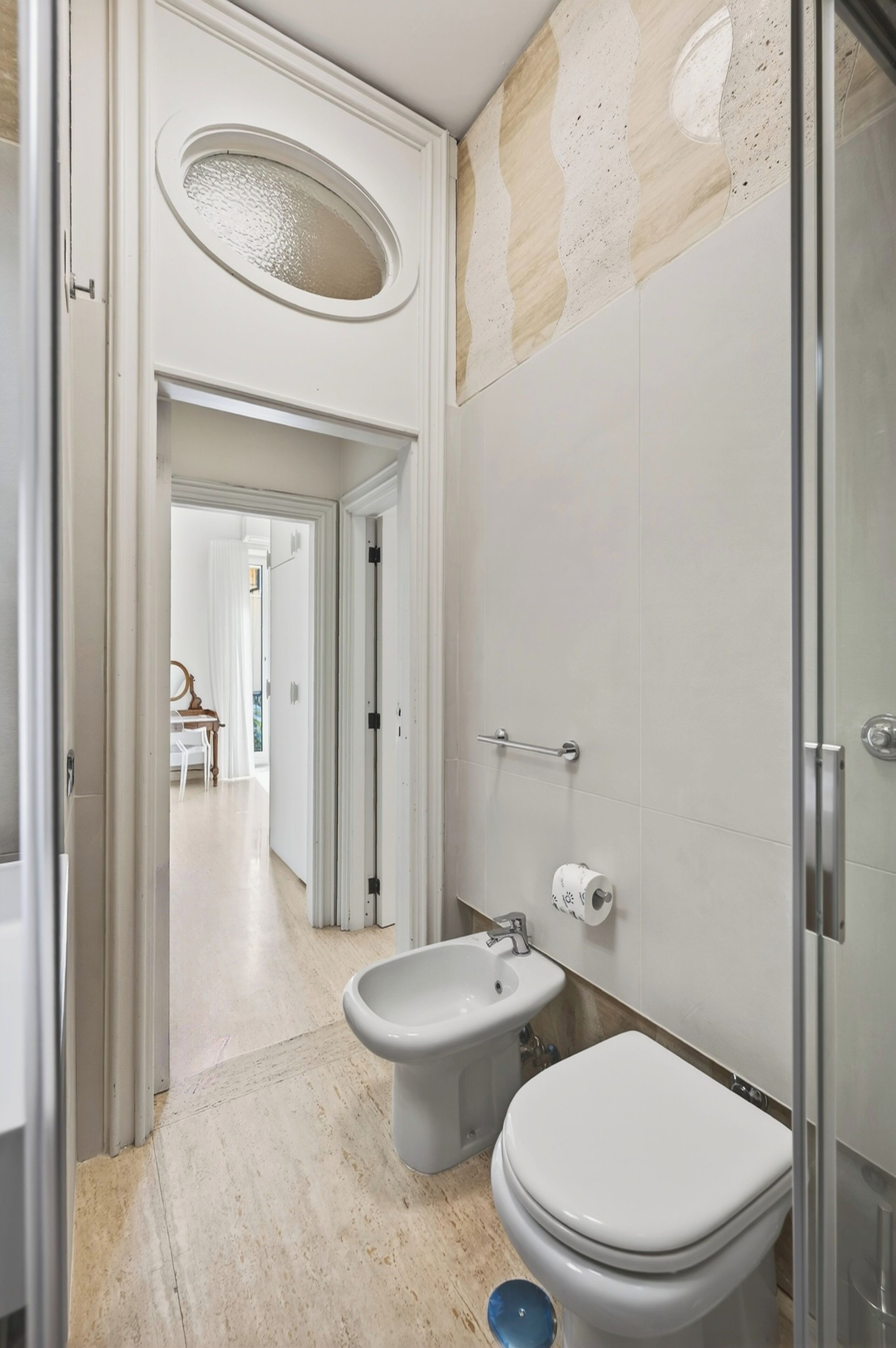 A bathroom with a toilet, bidet, and sink.