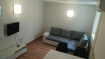 City Apartment, 1 Bedroom | Living area | 52-cm flat-screen TV with cable channels, LCD TV