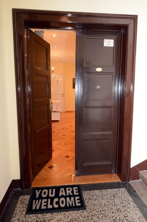 A wooden door with a 'You are welcome' mat at the entrance. - Apartment Tatjana (Zagreb)