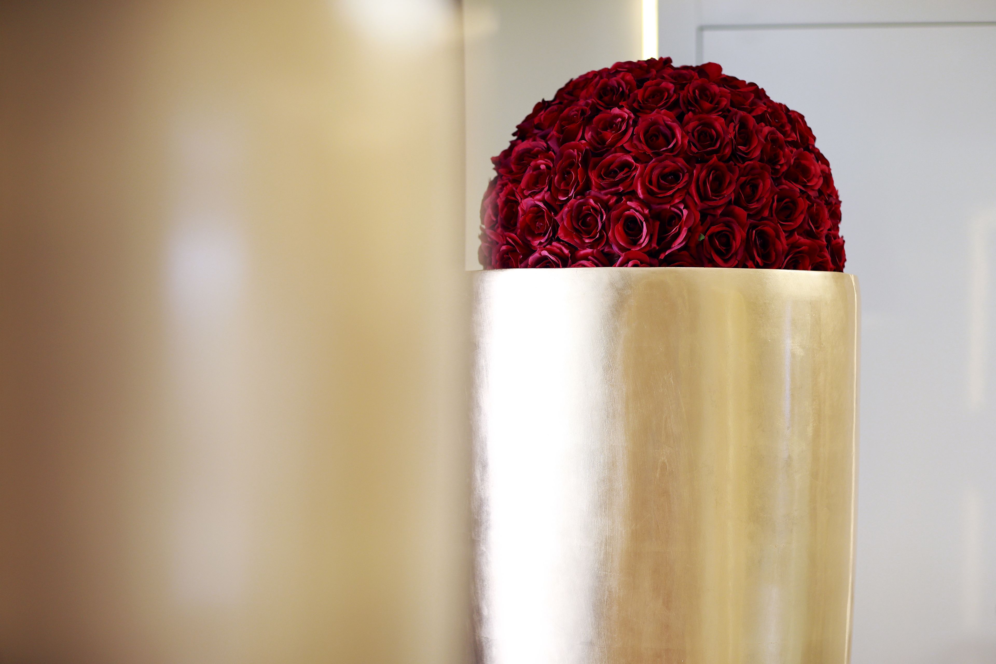 A cylindrical object with a red rose arrangement on top.