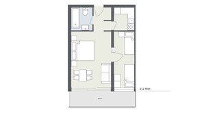 Un plan d’étage d’une chambre d’hôtel comprenant un balcon, une salle de bain, un coin repas et une kitchenette.