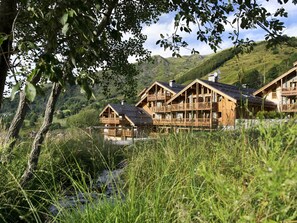 Escape to a tranquil mountain retreat with balconies and traditional cabin architecture.