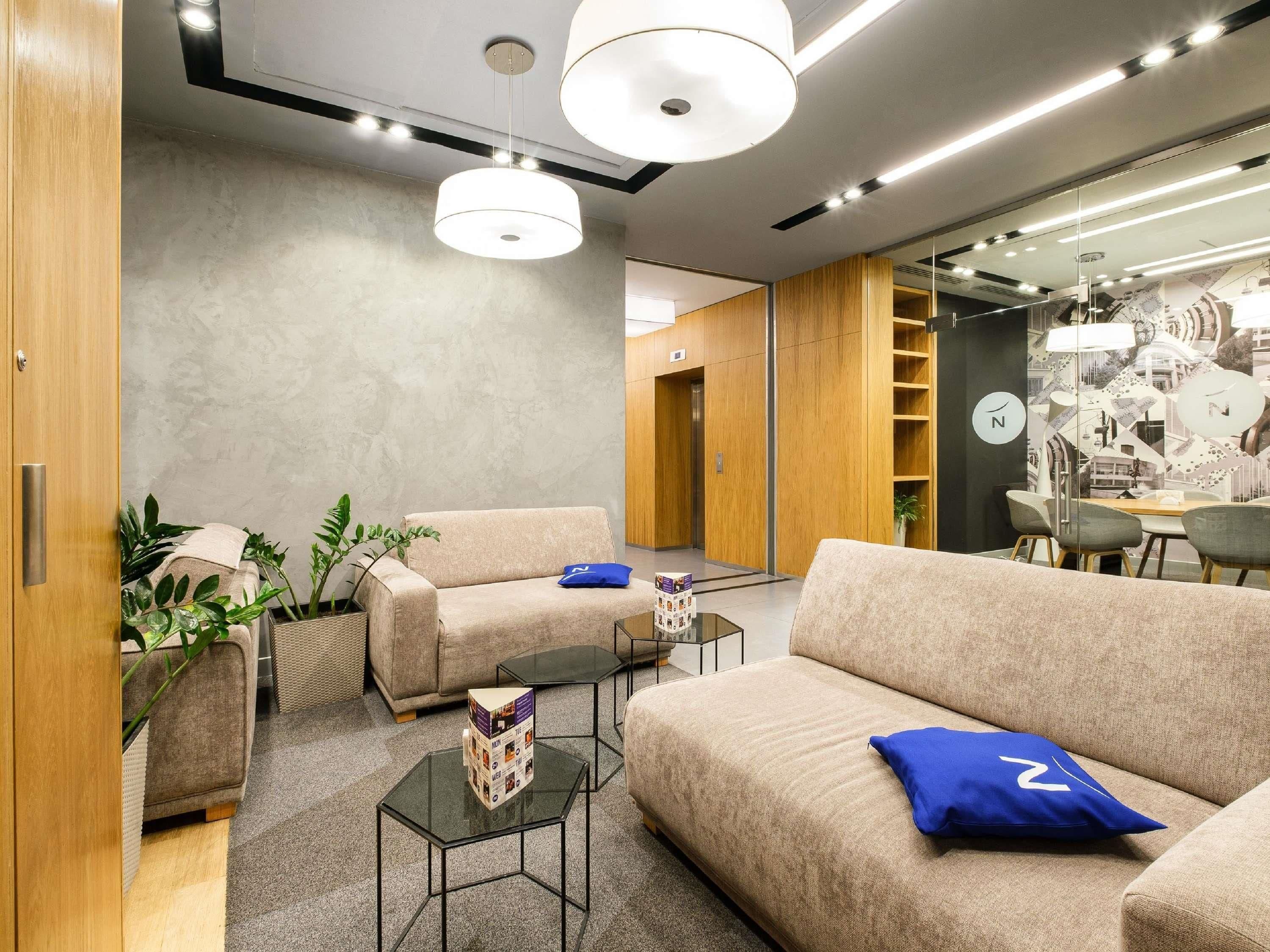 A modern interior with sofas, a coffee table, and a dining area.
