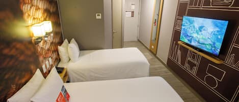 A hotel room with two single beds, a TV, a wall-mounted lamp, and a door leading to another room.