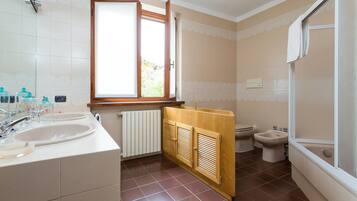 Un bagno con due lavandini, un WC e una doccia.