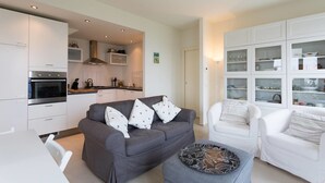 A modern living room with a grey sofa, white armchairs, and a dining table. - Contemporary 3 Bed Italian Lakes Villa, Lake Views, Wifi, BBQ (Massino Visconti)
