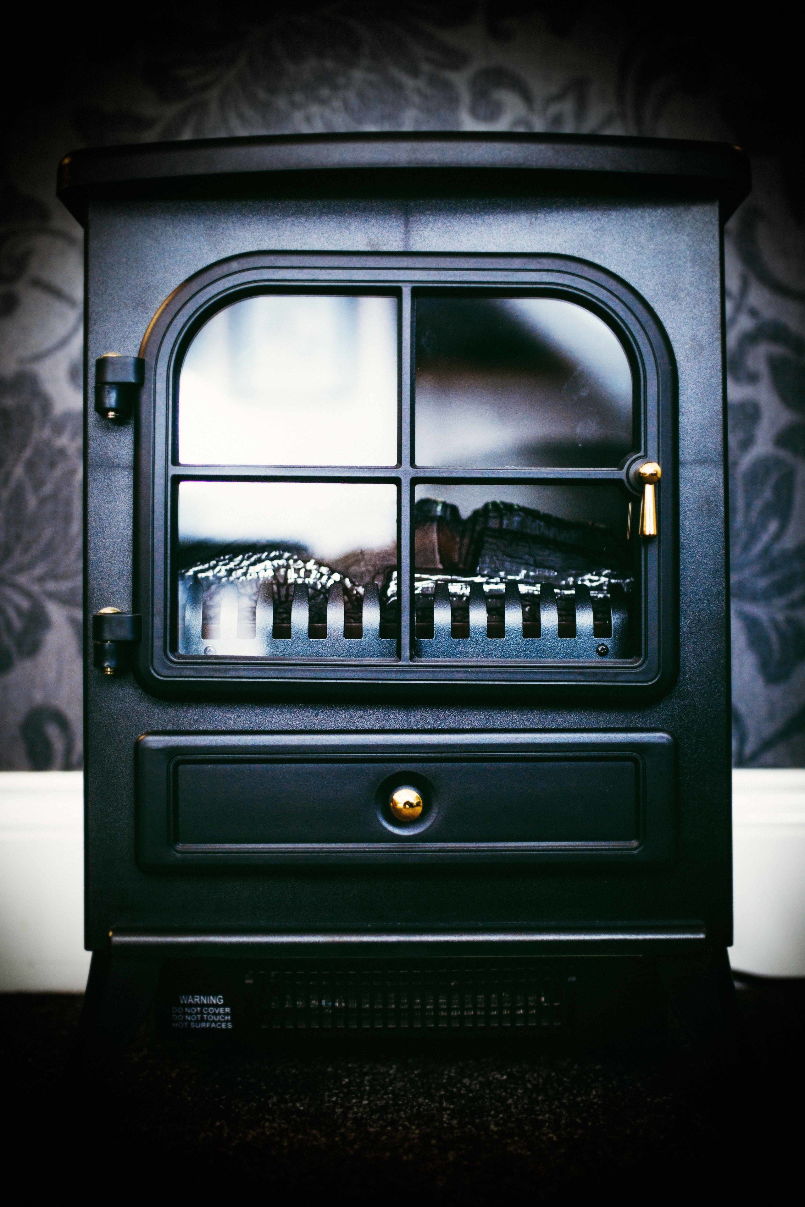 A vintage stove with a window and a door.