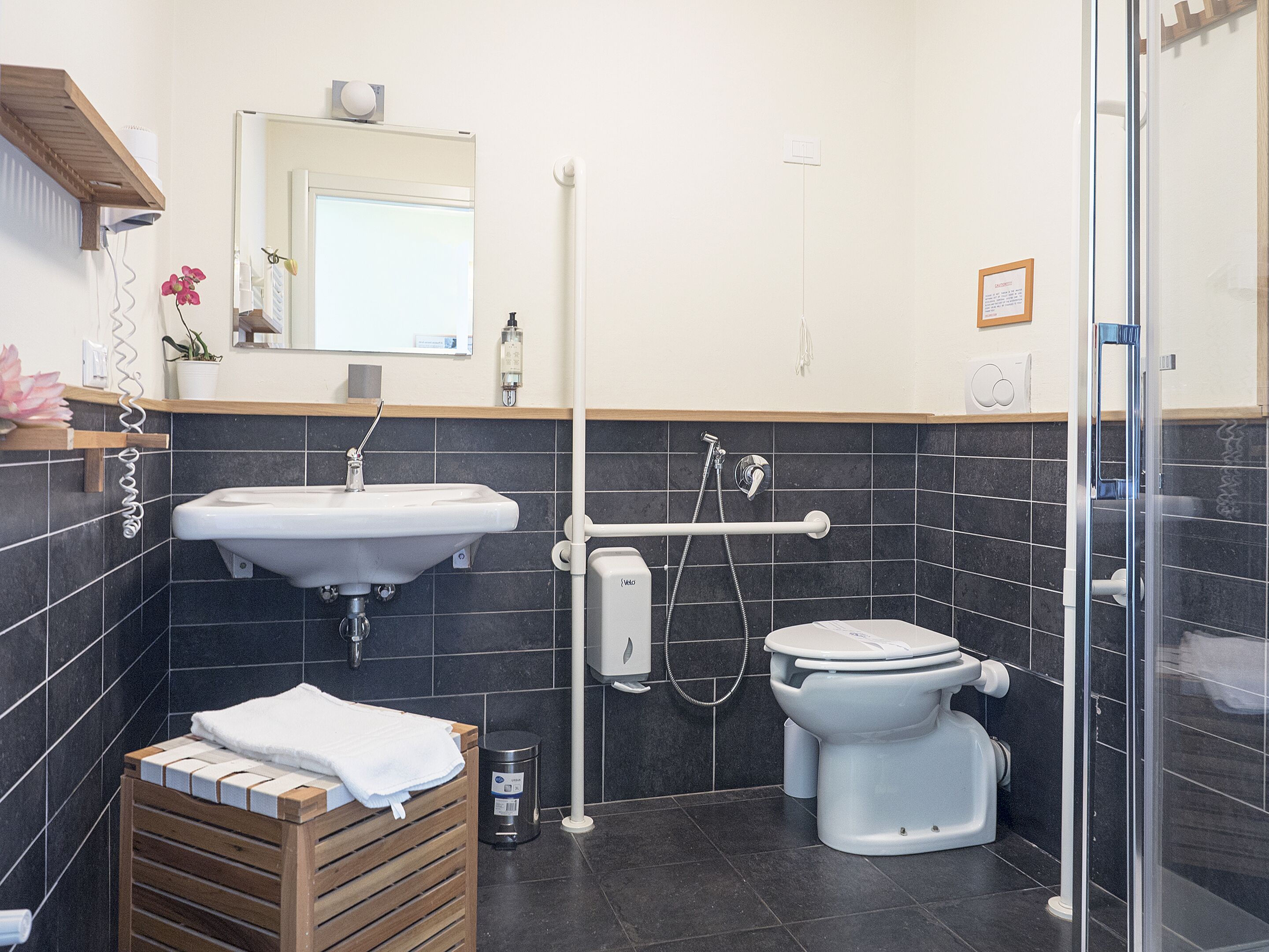 A modern bathroom with a sink, toilet, and shower.