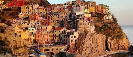 A coastal village with colorful buildings perched on a cliff.