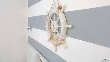 A nautical-themed wall decoration with a rope hammock.