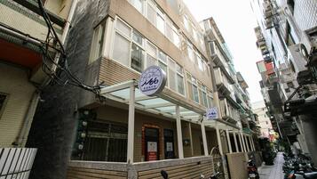 A multi-story building with a sign indicating a business establishment.