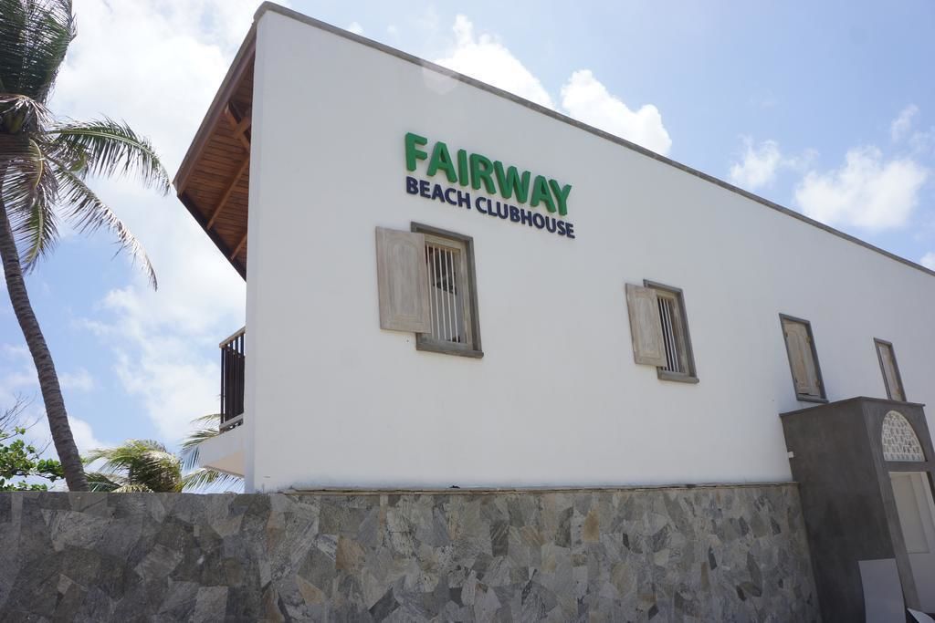 A building with the sign "FAIRWAY BEACH CLUBHOUSE".