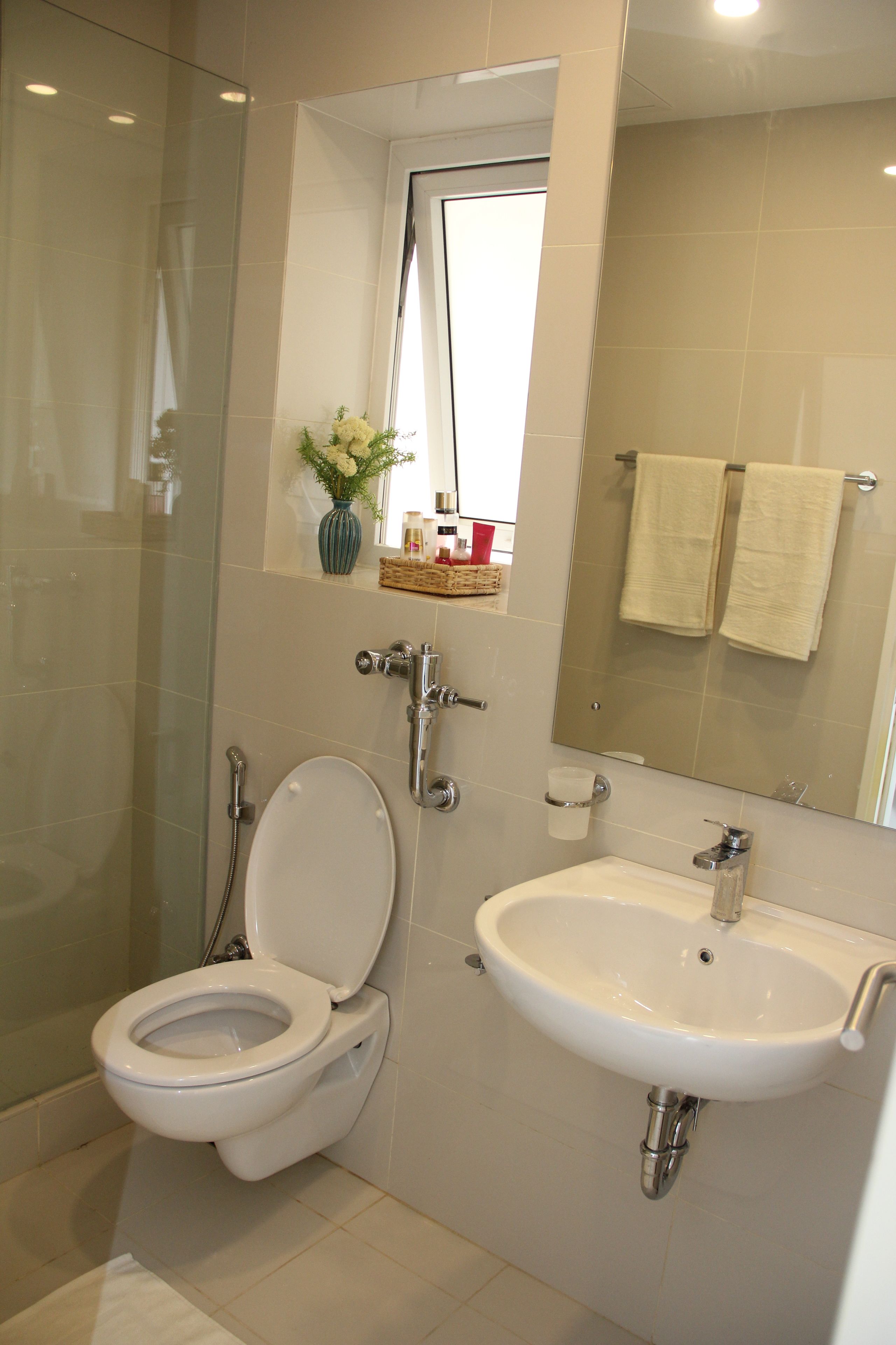 A bathroom with a toilet, sink, and shower.