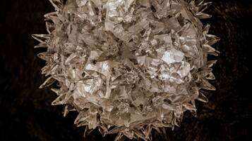 A spherical chandelier with multiple crystal elements.