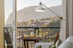 Enjoy a leisurely breakfast on the balcony with a scenic view of the surrounding hills.