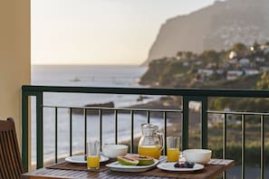Enjoy a meal on the balcony with a view of the sea and surrounding coastline.