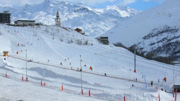 A snow-covered ski slope with ski lifts, buildings, and mountains in the background. - Classic studio 19m², South, pets OK, Les Menuires (Les Menuires)